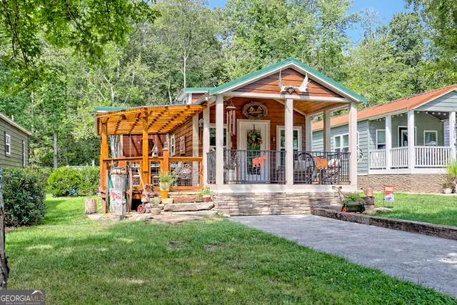 a front view of a house with a yard table and chairs