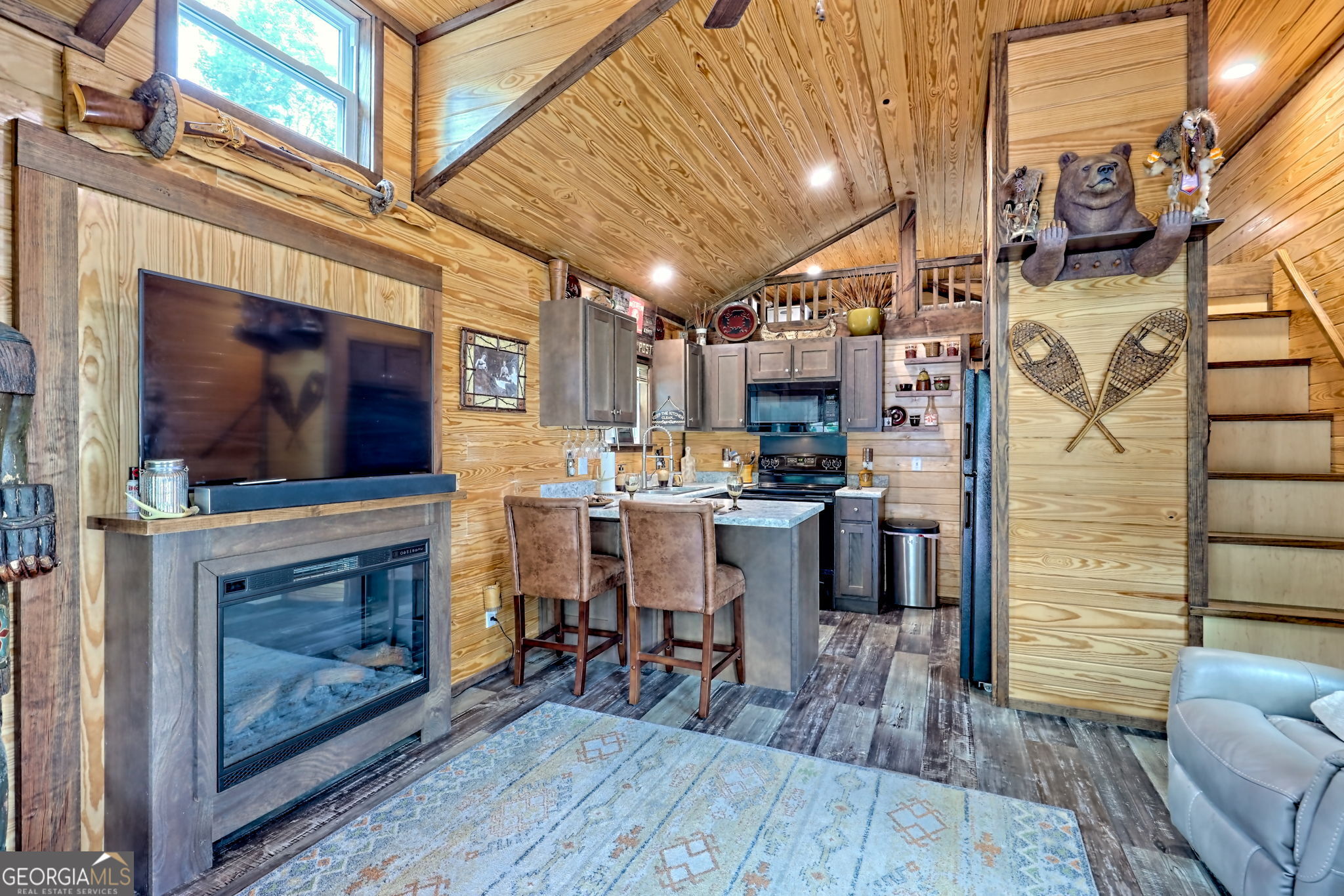 4960 Laurel Lodge Road, Unit 18 Clarkesville, GA 30523 - Photo 13 of 59 a living room with stainless steel appliances kitchen island granite countertop furniture and a fireplace