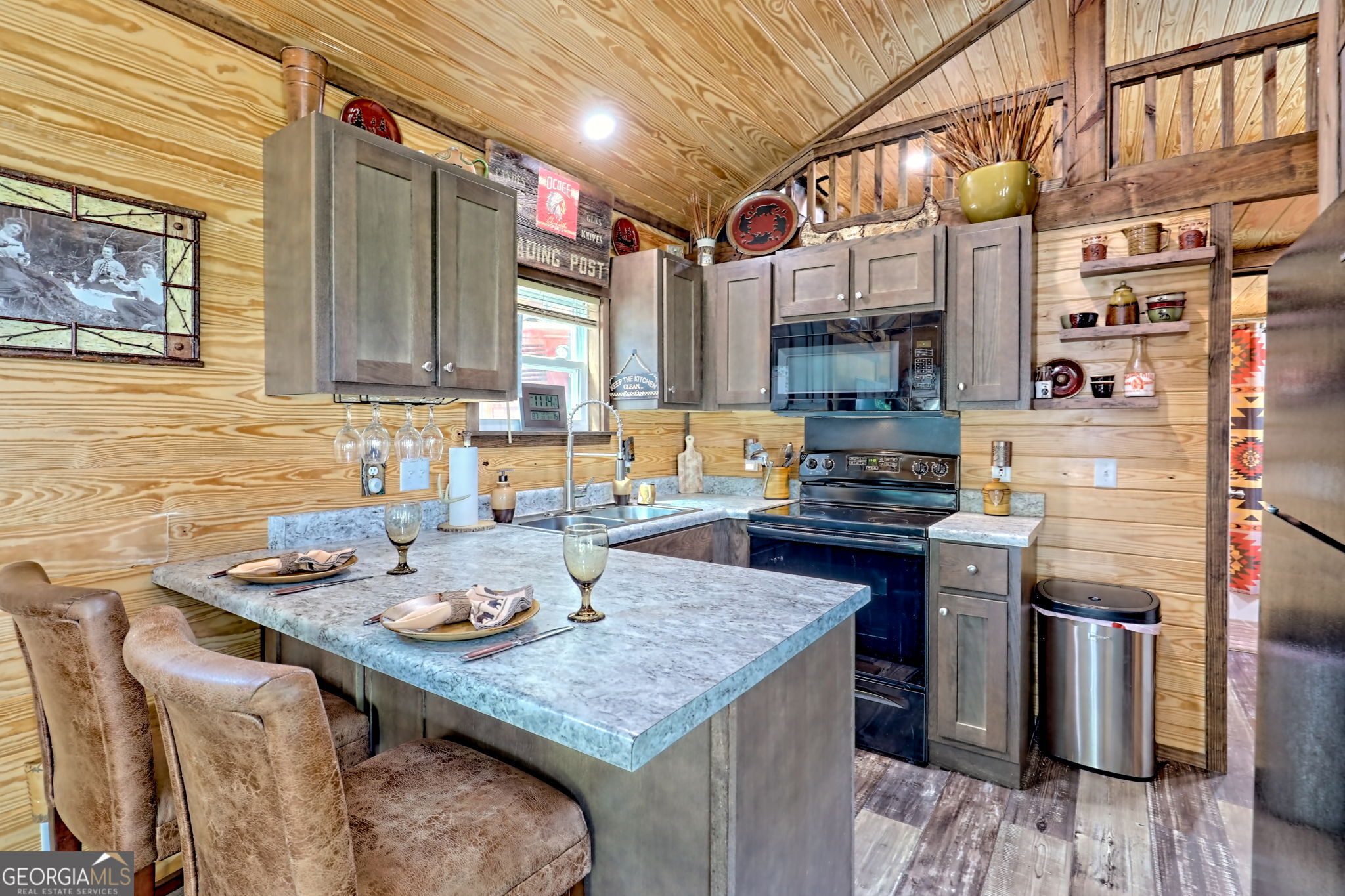 4960 Laurel Lodge Road, Unit 18 Clarkesville, GA 30523 - Photo 17 of 59 a kitchen with a sink a stove and chairs