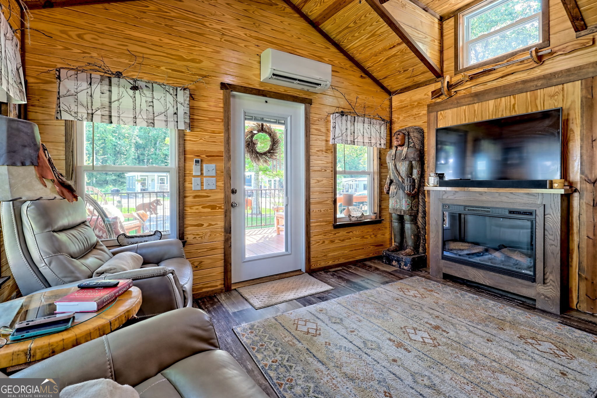 4960 Laurel Lodge Road, Unit 18 Clarkesville, GA 30523 - Photo 35 of 59 a living room with furniture a flat screen tv and a fireplace