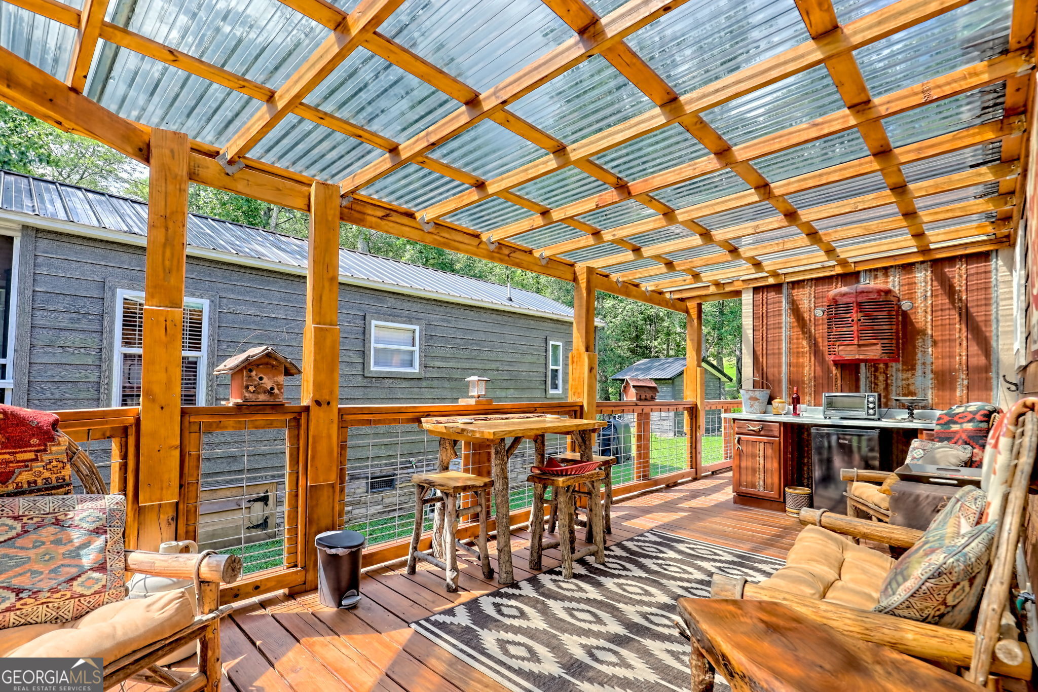4960 Laurel Lodge Road, Unit 18 Clarkesville, GA 30523 - Photo 38 of 59 a view of a patio with a table and chairs and wooden floor
