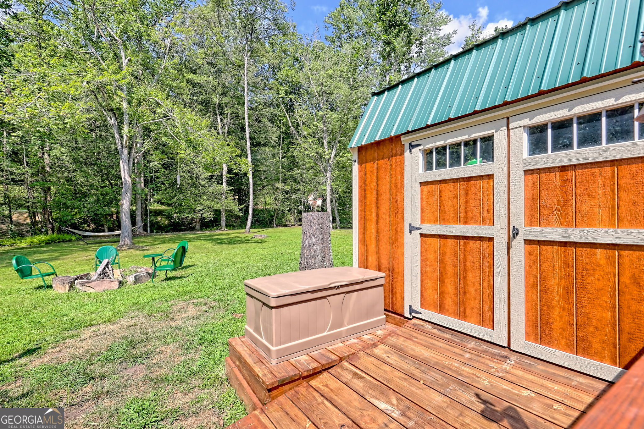 4960 Laurel Lodge Road, Unit 18 Clarkesville, GA 30523 - Photo 45 of 59 a backyard of a house with barbeque oven table and chairs