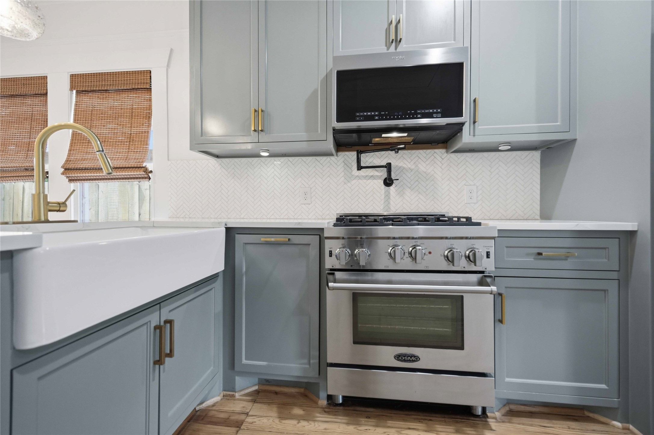 208 Archer Street Houston, TX 77009 - Photo 11 of 26 Stainless steel gas range with pot filler and microwave.