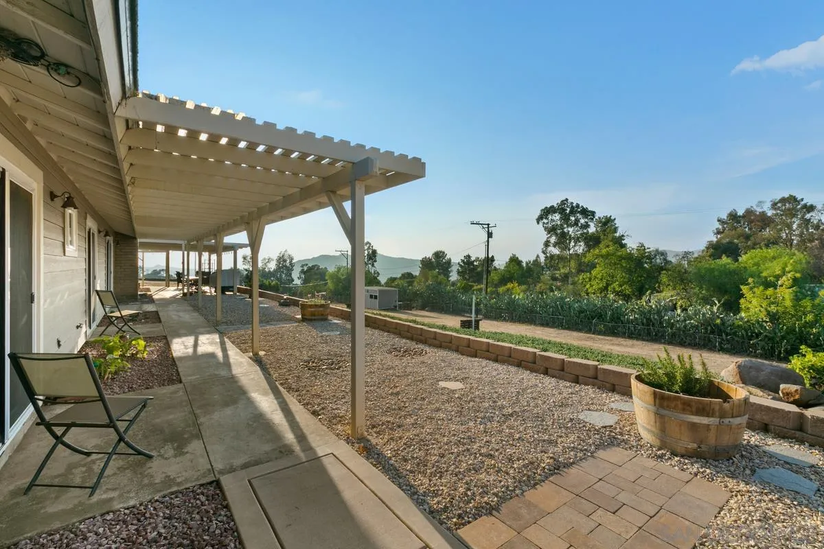 738 Lilac Ranch Road Alpine, CA 91901 - Photo 41 of 72 a view of a patio with table and chairs potted plants with sky view