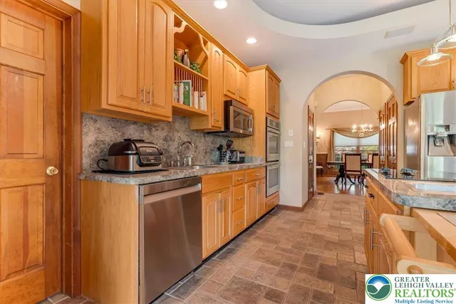 a kitchen with cabinets a sink and appliances