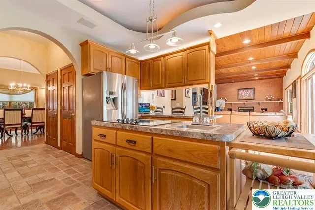 a kitchen with stainless steel appliances granite countertop a stove and cabinets