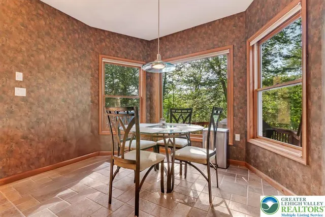 a view of a patio with table and chairs and potted plants