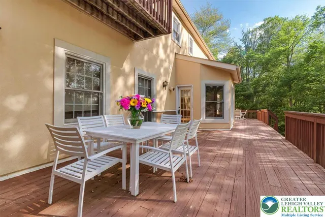 a view of a dining room with furniture large windows and wooden floor