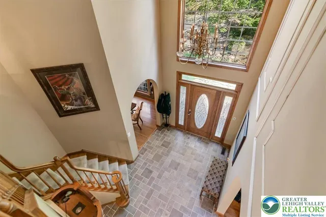 a bedroom with a bed dresser and a large window