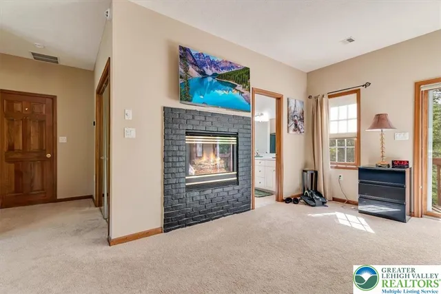 a bedroom with a bed and glass walk in closet