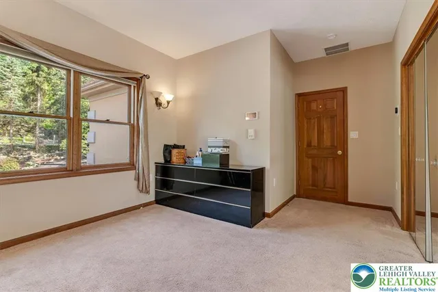a living room with a wooden floor and closet