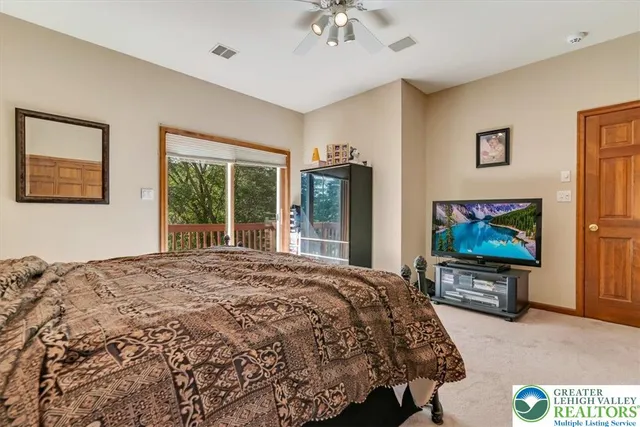 a bed sitting in a spacious bedroom next to a window