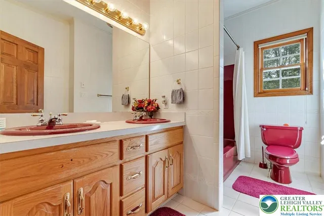 a view of an empty room with stairs and a couch