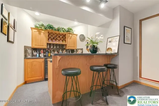 a room with pool table and windows