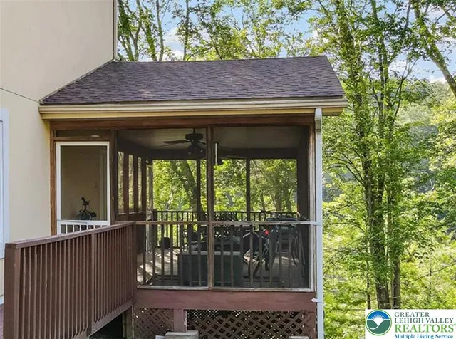 a view of a chairs and table in patio with wooden fence