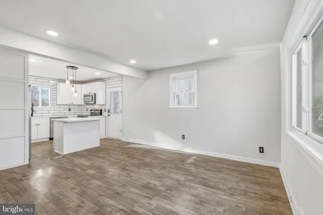 a view of kitchen with wooden floor and electronic appliances