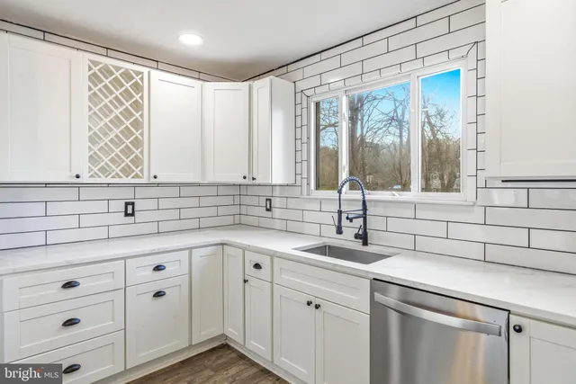 a kitchen with a sink and cabinets