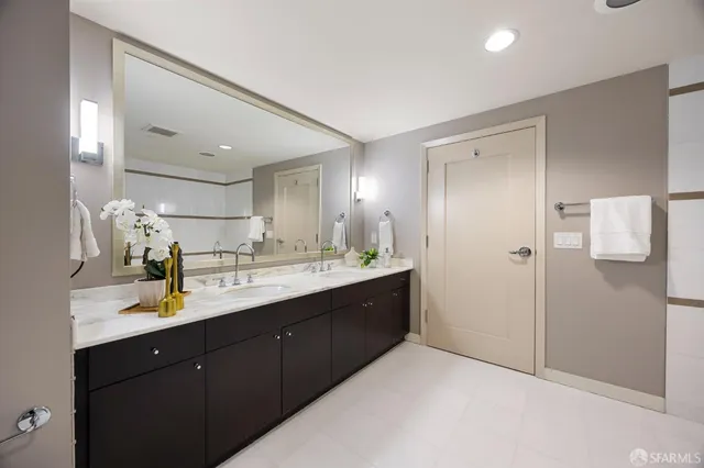 a bedroom with bed and a large window