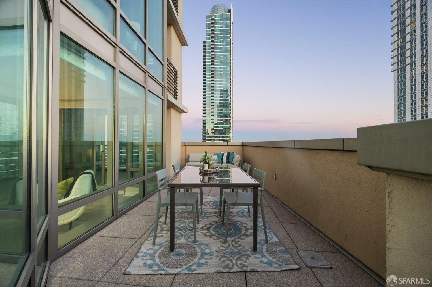 355 1st Street, Unit S2503 San Francisco, CA 94105 - Photo 39 of 67 a table and chairs sitting in front of a glass door