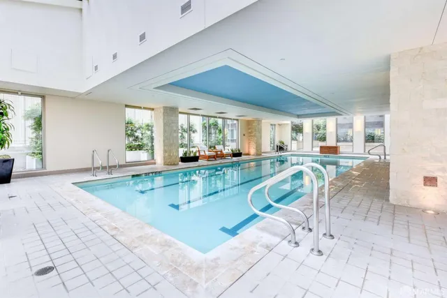 a city street with cars and palm trees