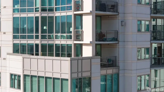 a living room with furniture and floor to ceiling windows