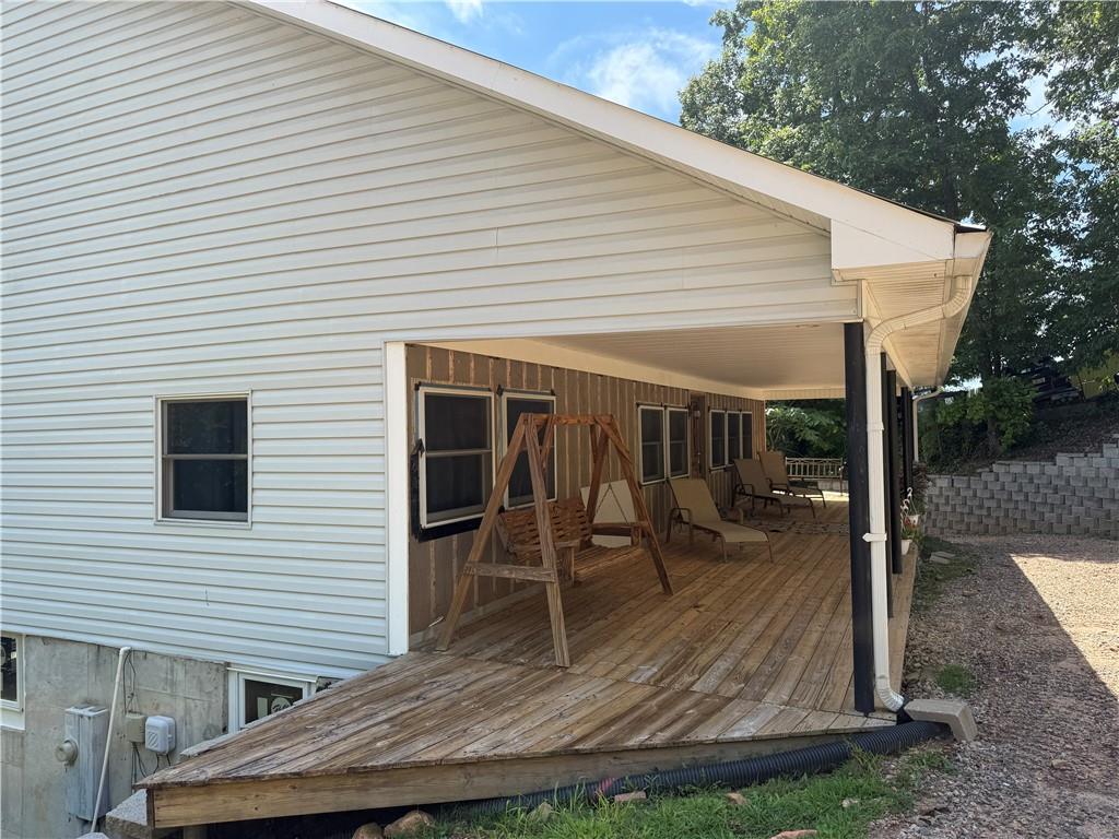 4265 Sinclair Shores Road Cumming, GA 30041 - Photo 14 of 18 a view of a patio with table and chairs with wooden floor and fence