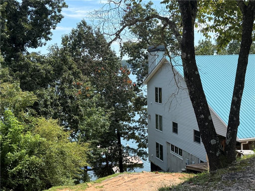 4265 Sinclair Shores Road Cumming, GA 30041 - Photo 2 of 18 a view of a house with a tree in front of it
