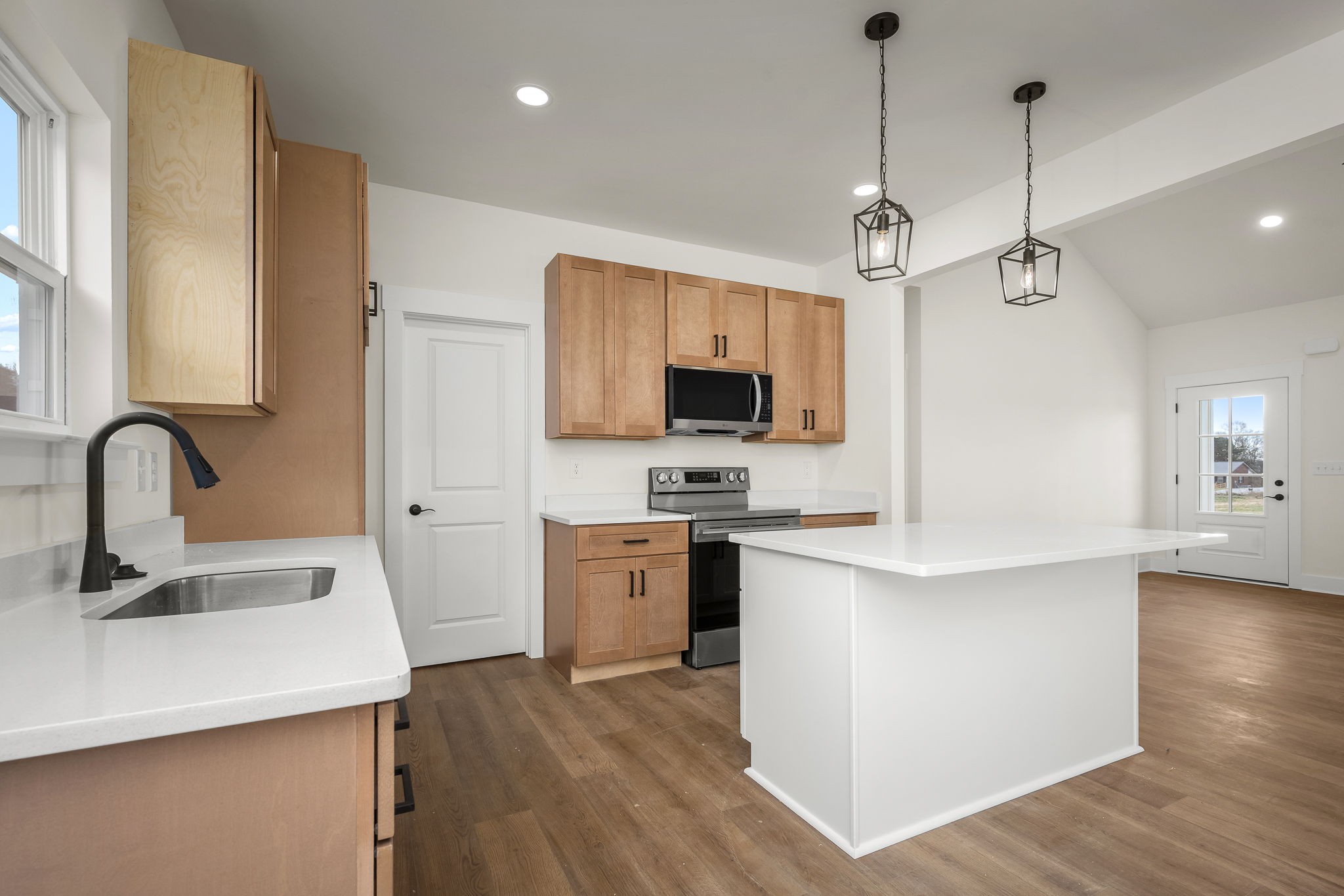 4151 Asbury Road Manchester, TN 37355 - Photo 14 of 32 a kitchen with stainless steel appliances a sink a stove a refrigerator cabinets and wooden floor