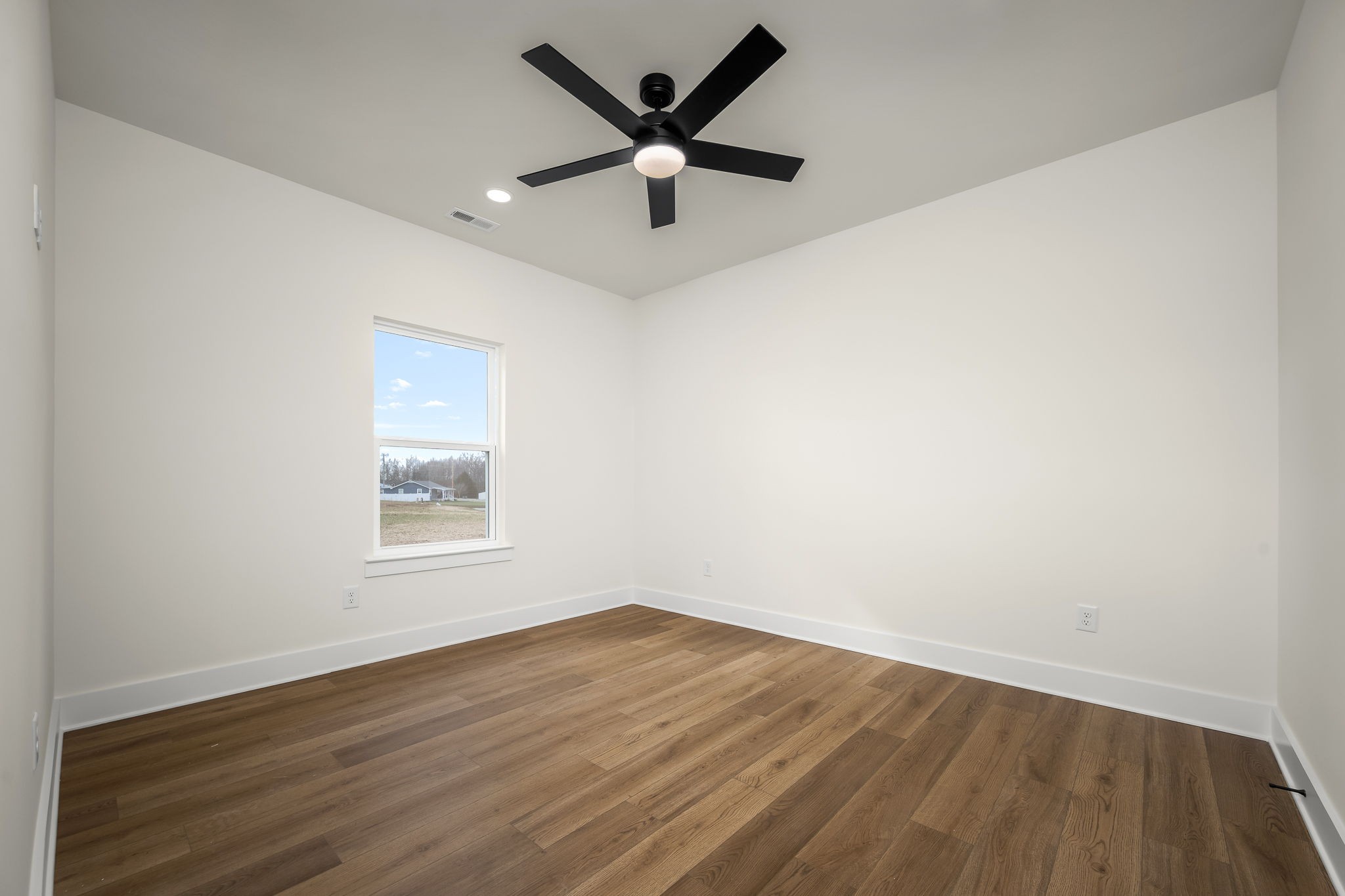 4151 Asbury Road Manchester, TN 37355 - Photo 23 of 32 an empty room with wooden floor and ceiling fan