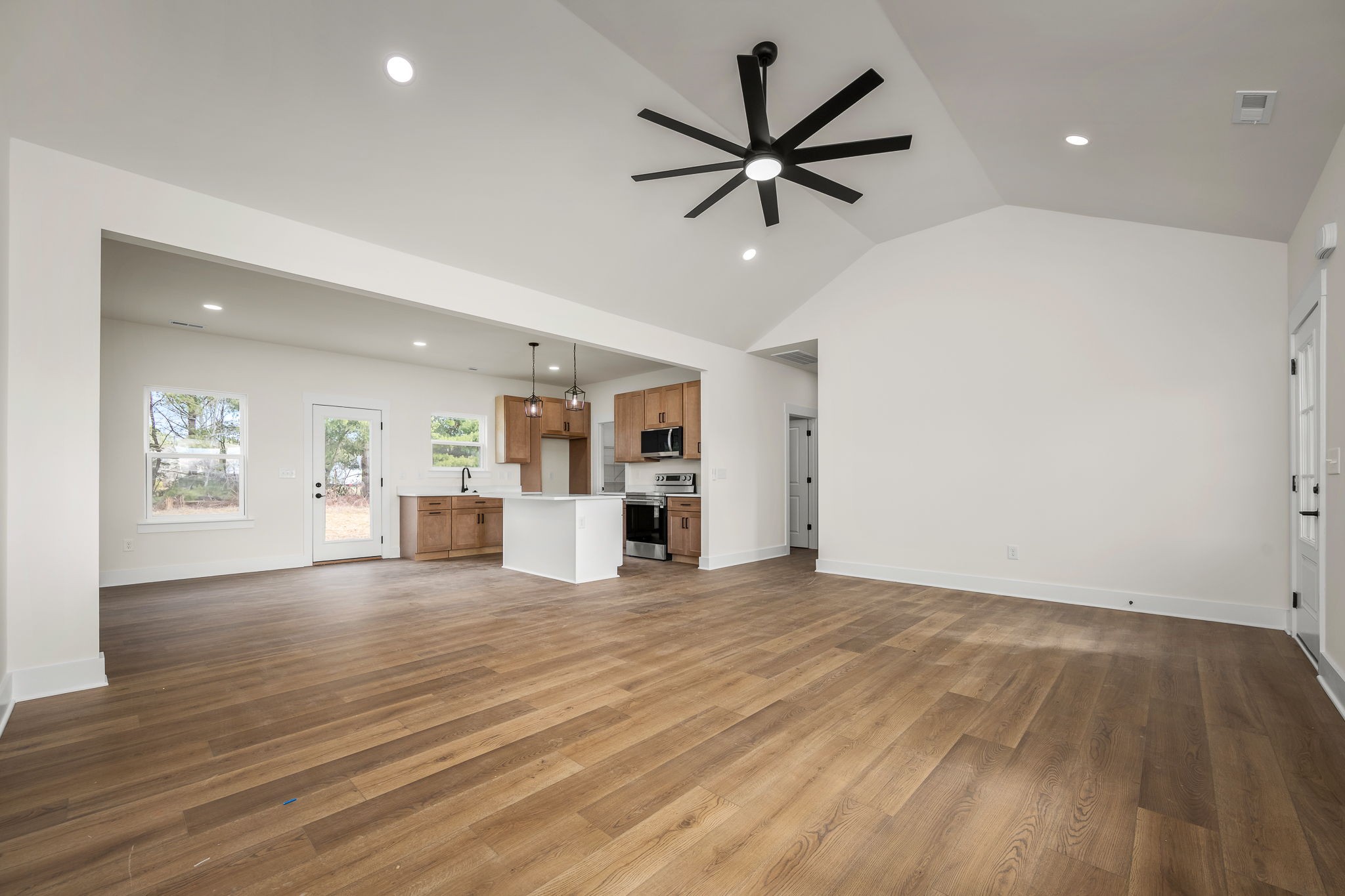 4151 Asbury Road Manchester, TN 37355 - Photo 9 of 32 a view of a livingroom with a ceiling fan and wooden floor