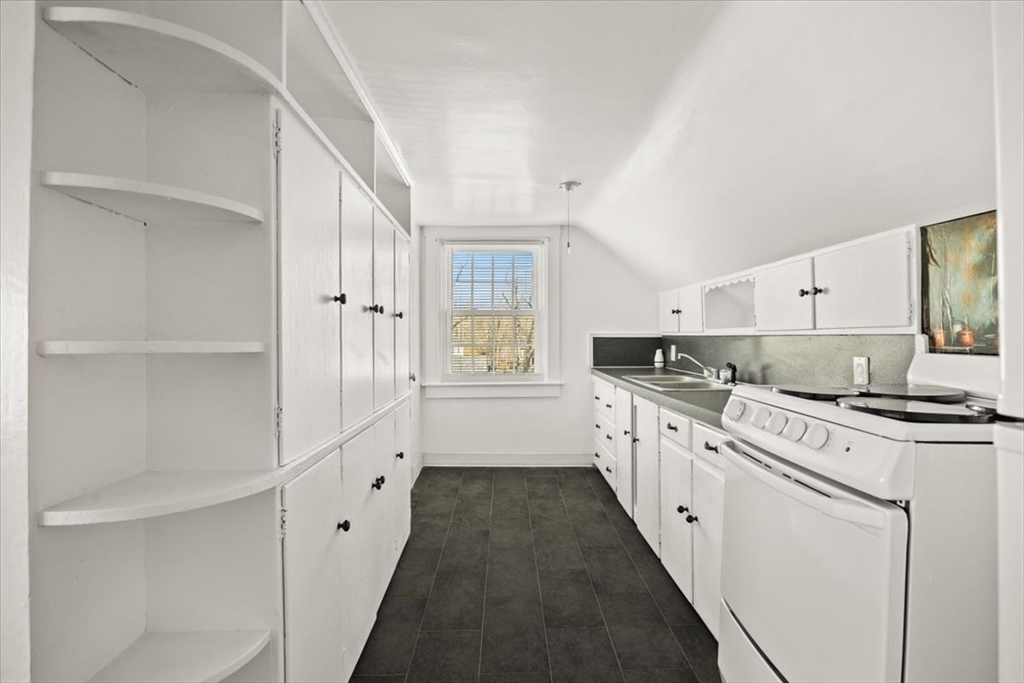 1 Elm Street, Unit 3 Freetown, MA 02702 - Photo 4 of 16 a kitchen with granite countertop white cabinets and white appliances