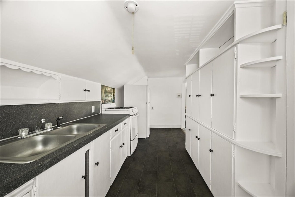 1 Elm Street, Unit 3 Freetown, MA 02702 - Photo 5 of 16 a kitchen with granite countertop a sink and cabinets