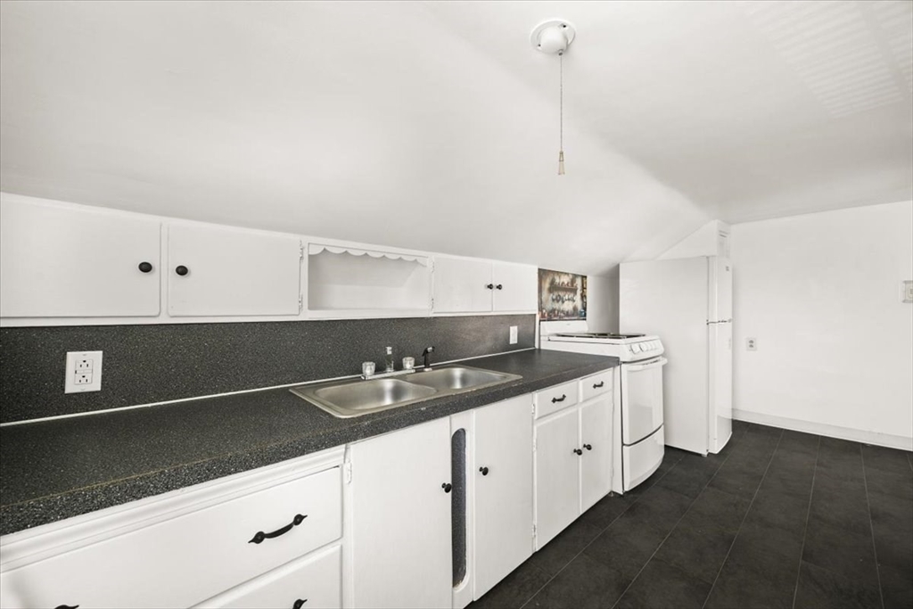1 Elm Street, Unit 3 Freetown, MA 02702 - Photo 6 of 16 a kitchen with granite countertop a sink and cabinets