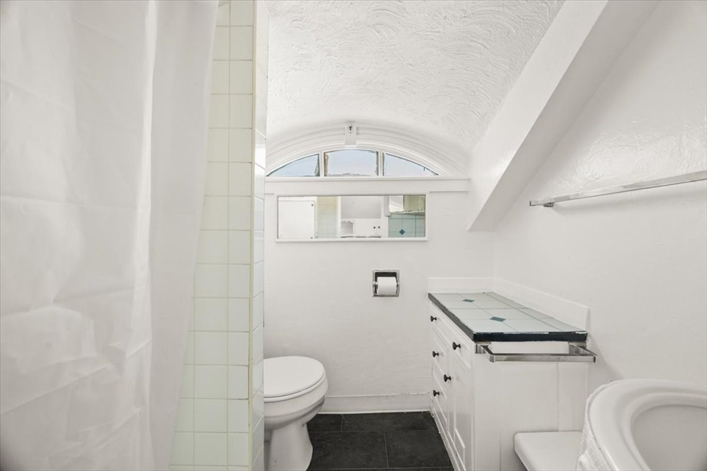 1 Elm Street, Unit 3 Freetown, MA 02702 - Photo 9 of 16 a white toilet sitting next to a bathroom sink