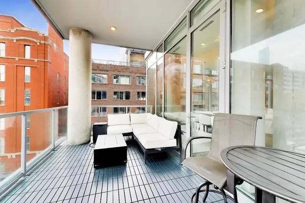 a living room with furniture and a floor to ceiling window