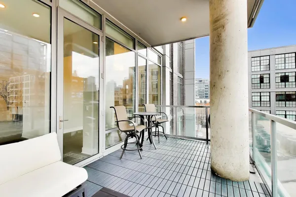 a living room with furniture and a floor to ceiling window