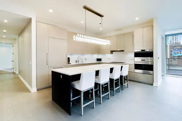 a large kitchen with a table and chairs
