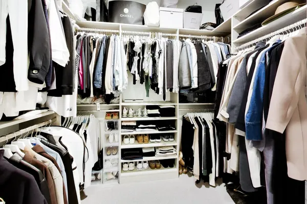 a view of walk in closet with clothes and shoes