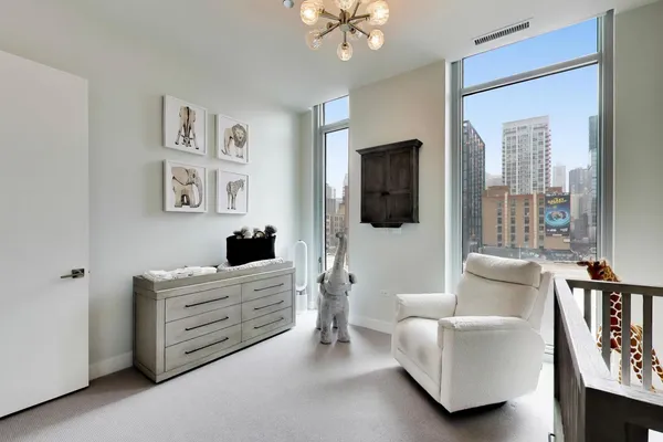 a bedroom with furniture and a flat screen tv