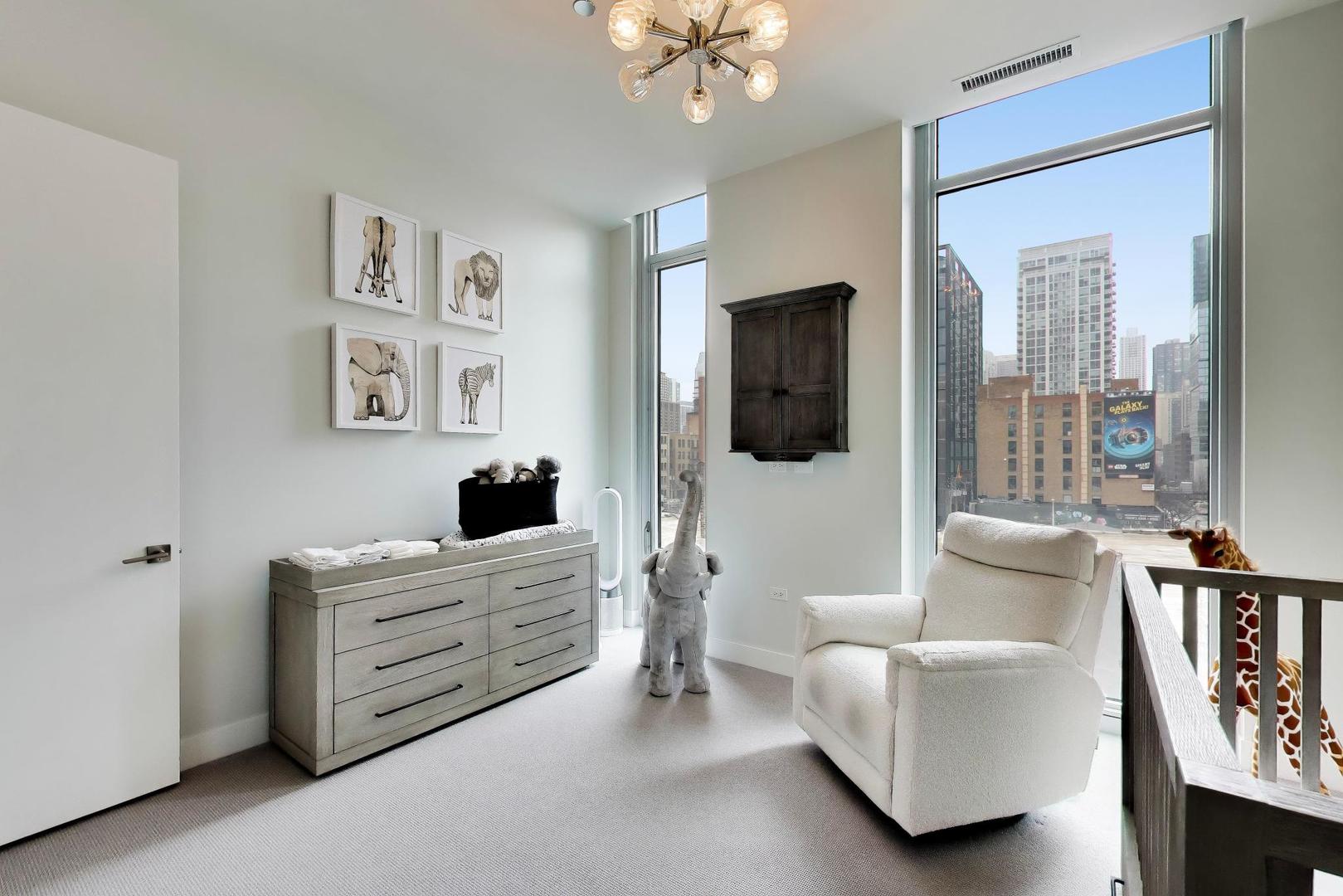 360 West Erie Street, Unit 5D Chicago, IL 60654 - Photo 24 of 41 a bedroom with furniture and a flat screen tv