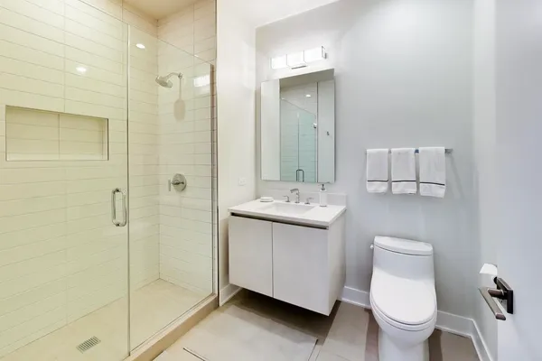 a bathroom with a toilet sink and shower