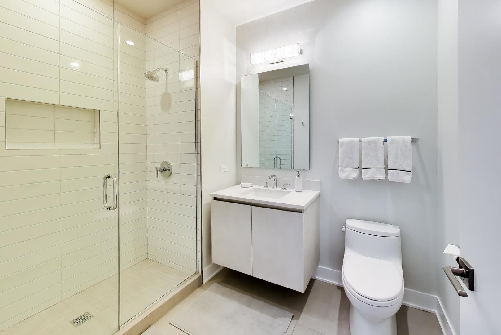 360 West Erie Street, Unit 5D Chicago, IL 60654 - Photo 26 of 41 a bathroom with a toilet sink and shower