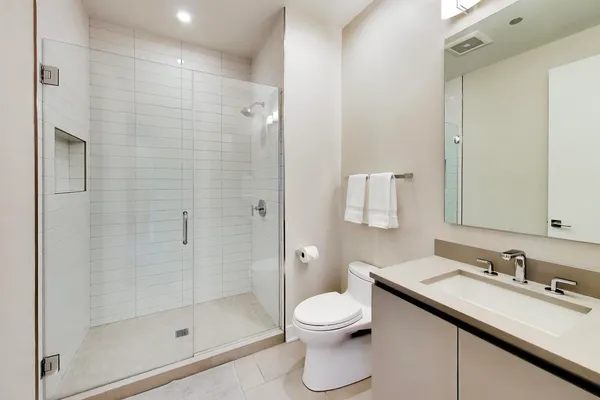 a bathroom with a sink shower and a toilet