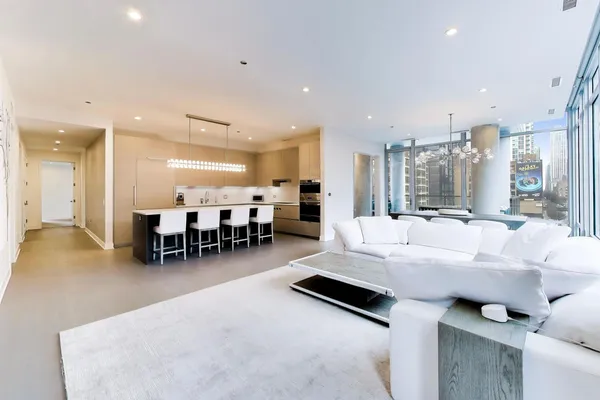 a living room with furniture and kitchen view