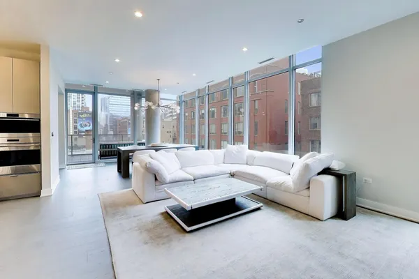 a living room with furniture and large windows