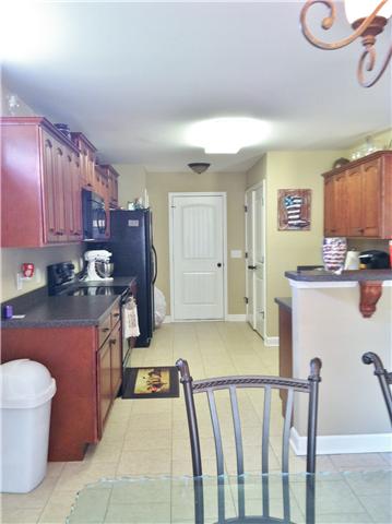 111 Legends Ridge Drive Lebanon, TN 37090 - Photo 3 of 13 Dark wooden cabinetry with two panties... lots of storage in kitchen