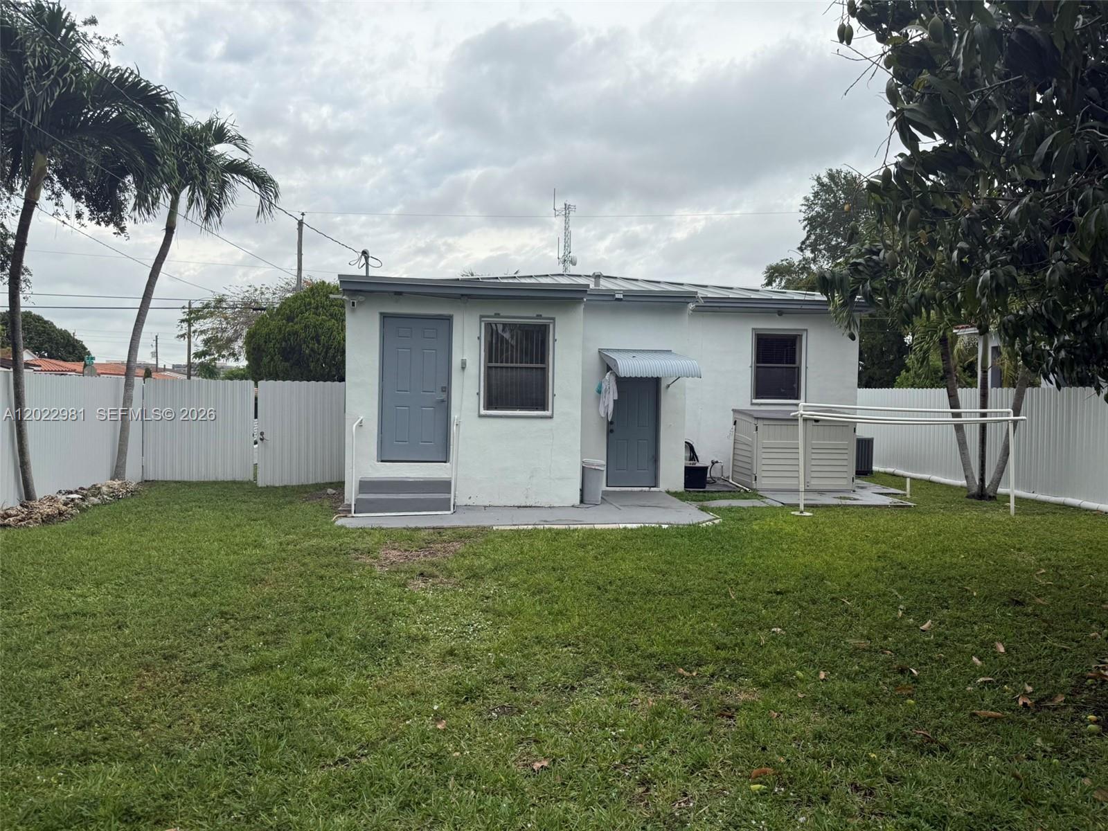 5940 Southwest 2nd Street Miami, FL 33144 - Photo 7 of 22 a front view of house with yard and trees