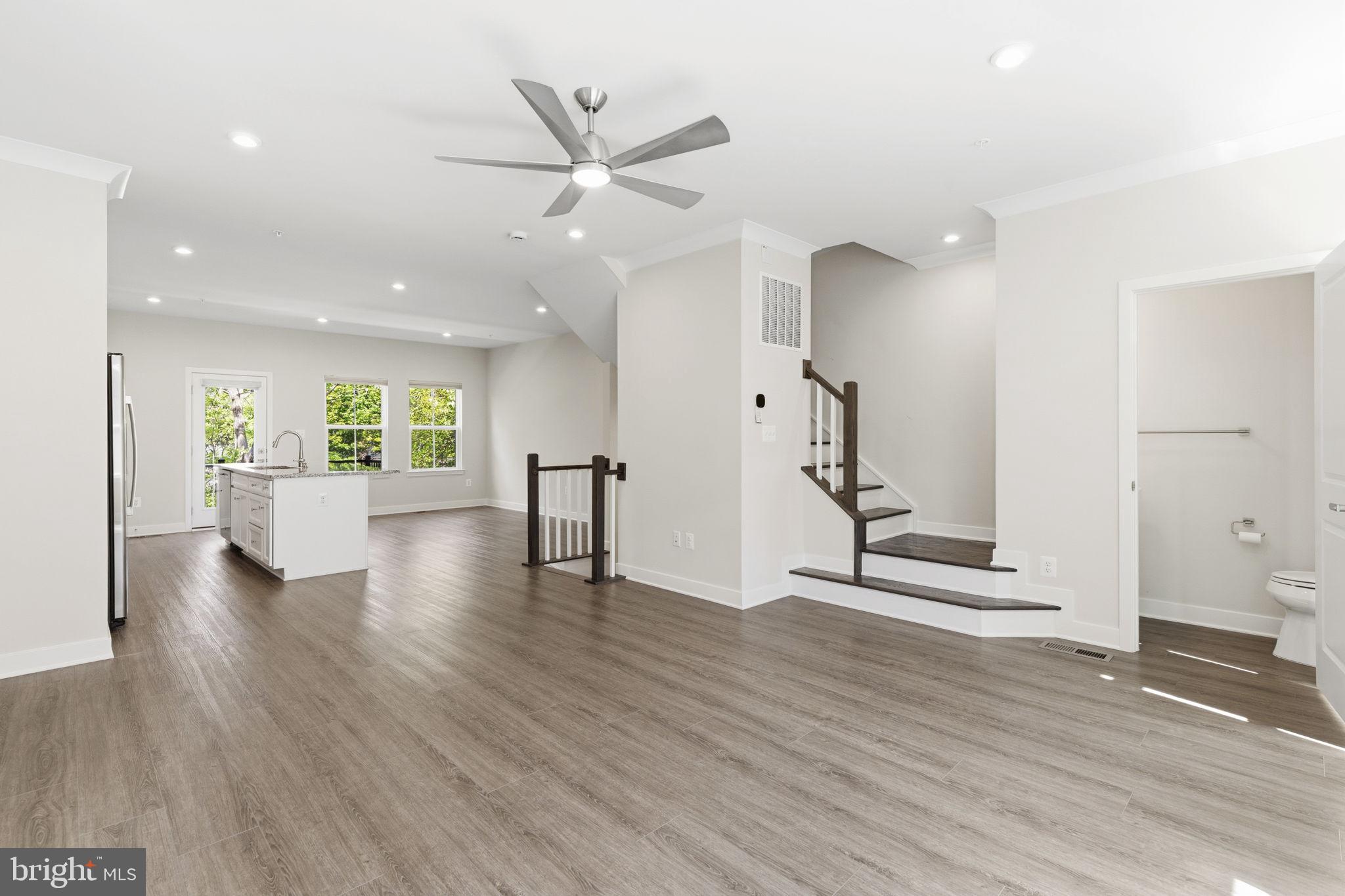 1566 Lowman Street Baltimore, MD 21230 - Photo 11 of 47 a view of an empty room with wooden floor and a ceiling fan