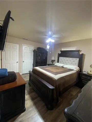a bedroom with a bed and a television