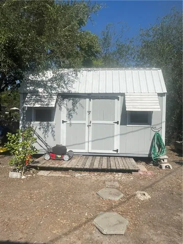 a backyard of a house with lots of green space and fountain